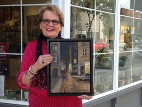 Artist Dagmar Vrkljan holds up a streetscape of Prague outside Artopia in downtown Sarnia. The 65-year-old local artist will be staging her first exhibit since 2007 at October's First Friday festivities. SUBMITTED PHOTO / THE OBSERVER / QMI AGENCY