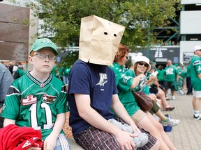 A Winnipeg Blue Bomber fan hides his head in a paper bag before the Labour Day Classic football game between the Saskatchewan Roughriders and the Winnipeg Blue Bombers in Regina, Saskatchewan September 1, 2013. REUTERS/David Stobbe (CANADA - Tags: SPORT FOOTBALL)