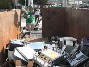 Jody Steele tosses a computer into a dumpster during Tuesday's IT Recycle Games on the Queen's University campus, part of Sustainability Week when Queen's highlights its green initiatives. (Michael Lea The Whig-Standard)