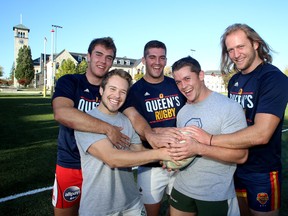 Queen's Golden Gaels rugby players, from left, Dave Worsley, Keegan Myers, Jacob Rumball, Brendan Sloan and Tommy Kirkham, at Nixon Field in Kingston on Wednesday, are raising money for the CIBC Run For the Cure on Sunday. (Ian MacAlpine The Whig-Standard)