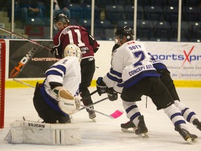 Kyle Brothers of the Chatham Maroons scores a powerplay goal on a backhand behind Nat's goalie Liam Herbst, late in the first period of their game against the London Nationals at Western Fair Sports Centre Wednesday Oct 2, 2013 evening.
Chasing the play for the Nationals is Matt Doty and Matt Wildman.
The Maroons were up 2-1 after 1 period of play in London, Ont.
MIKE HENSEN/The London Free Press/QMI AGENCY