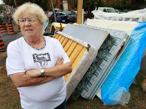 Glenna Murdoch stands by damaged mattresses at her apartment on Charlotte Street. Murdoch lives in a Ottawa Community Housing seniors' building that is infested with bed bugs. People from the building have thrown out their beds. Tony Caldwell/Ottawa Sun