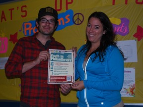 Talbot Teen Centre manager Matt Cossette, left, and volunteer and fundraising coordinator Kendall O'Neill hold a poster about the new Youth in Philanthropy St. Thomas-Elgin council at the teen centre on Friday, Oct. 4, 2013. The philanthropy council launches next week as a group of teens and 20-somethings committed to making a positive change in the community. (Ben Forrest, Times-Journal)