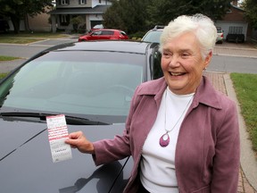 Janet Gollan of Kingston holds up a parking ticket she received in September. She paid for the ticket but doesn't think she should have received it in the first place. 
IAN MACALPINE/KINGSTON WHIG-STANDARD/QMI AGENCY