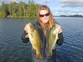 Ashley Rae with a largemouth and smallmouth bass caught and released on Loughborough Lake. (Supplied photo)