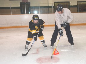 Alex Ostrowalker, left, gets some tips on stance from Matt Jamieson during a minor hockey development day workshop Saturday at the West Elgin Arena.