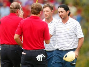 International team players Justin Day (R) of Australia and Graham DeLaet of Canada (2nd from R) shake hands with Steve Stricker (L) and Jordan Spieth of the U.S. after Day and DeLaet won their four ball match at the 2013 Presidents Cup golf tournament at Muirfield Village Golf Club in Dublin, Ohio October 5, 2013.  (REUTERS)