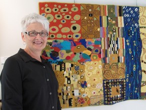 Hook craft artist Karen Rutledge stands with one of her pieces in the Hooked on Wool exhibition at Gallery in the Grove. The Sarnia Lambton Traditional Hook Crafters Guild show runs from Oct. 6 to Oct. 26. SUBMITTED/ FOR THE OBSERVER/ QMI AGENCY
