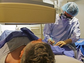 Dr. Nick Gambarotta inserts a multi-purpose tube into the arm of Wayne Hockney during a fluoroscopy procedure at Belleville General Hospital last Tuesday. The BGH Foundation is raising funds to pay for the cost of the machine and millions more in medical equipment, a cost not funded by government.
