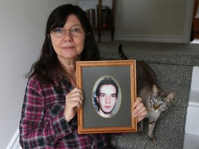 Carol Smith holds a photo of her son, Michael, who died of an overdose in 2011 using drugs he allegedly bought on the Silk Road website. (Elliot Ferguson The Whig-Standard)
