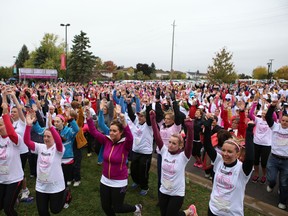 Participants warm up before Sunday’s Run for the Cure at St. Lawrence College. (Elliot Ferguson The Whig-Standard)