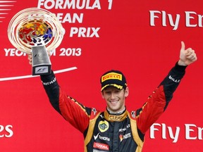 Romain Grosjean lifts his trophy after finishing third at the Korean Grand Prix on Sunday. (REUTERS)