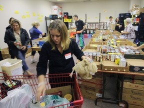 Tuesday Hughes is in the foreground of an energetic, but organized Helping Hand Food Bank ‘war room’ Saturday morning as ‘blitz’ items begin to arrive. Jeff Tribe/Tillsonburg News