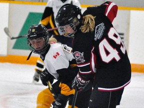 Sarah Skinner of the Mitchell Bantam girls checks this South Huron opponent during league action Sunday, Oct. 5 in Monkton - a 2-1 loss. ANDY BADER/MITCHELL ADVOCATE