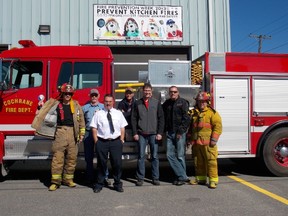 Roger Robin, Francis Dods, Richard Vallee, Bill Porter, Kurtis King, Darcy Labelle and Marc Grenon standing below the Fire Prevention Week banner at the fire hall.