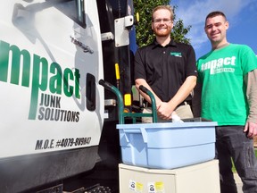 Impact Junk Removal’s Nick Soave, operations lead, and Greg McKeen, crew supervisor, stand next to their flatbed truck in London, Ont. October 7, 2013. Impact Junk Removal — a small business started by WOTCH Community Mental Health Services — is one example of a social enterprise in London. More can be found at a new website dedicated to the idea — www.seontario.org. CHRIS MONTANINI\LONDONER\QMI AGENCY