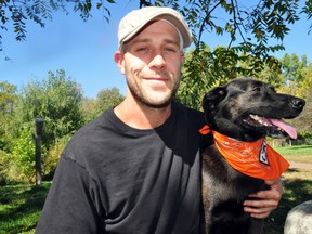 Graham Fowler, 32, and his dog Lila at the Stoney Creek Off-Leash Dog Park on Adelaide Street Oct. 2, 2013. Starting in November, Fowler plans to spend roughly 45 days hiking The Bruce Trail twice in honour of his grandmother, Sara Rie Larson, while raising funds for a scholarship in her name. CHRIS MONTANINI\LONDONER\QMI AGENCY