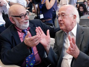 File picture of British physicist Peter Higgs (R) talking with Belgium physicist Francois Englert before a news conference on the search for the Higgs boson at the European Organization for Nuclear Research (CERN) in Meyrin near Geneva July 4, 2012.  REUTERS/Denis Balibouse/Files