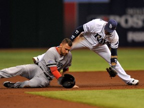 Boston Red Sox third baseman Will Middlebrooks is tagged out by Tampa Bay Rays shortstop Yunel Escobar during Game 4 of their American League Divisional Series on Tuesday night at Tropicana Field. (Steve Mitchell/USA TODAY Sports)