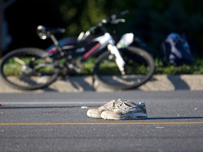 The victims shoes mark the spot where a cyclist collided with a van on Commissioners Road at Adare Cres. in London, Ontario on Tuesday, October 8, 2013. DEREK RUTTAN/ The London Free Press /QMI AGENCY