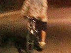 This cellphone photo shows one of the attackers during the incident. The suspect was wearing a white hooded sweatshirt with lettering or a graphic on the chest, dark shorts and white shoes.