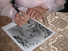 Donna Douglas, shown in this 2012 file photo signing autographs at Voice of Truth Church in Oil Springs, is set to appear at the Saturday, 10:45 a.m. at the Thanksgiving church service at the Brigden Fair. The fair runs Friday through Monday. PHOTO SUBMITTED/QMI AGENCY