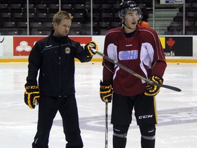 Sarnia Sting head coach Trevor Letowski gives forward Daniel Nikandrov some pointers on defensive positioning during practice on Wednesday, Oct. 9. The Sting host the London Knights on Thursday, and are in for a tough test against a Knights team ranked second in the country. (SHAUN BISSON, The Observer)