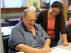 Swati Mahakul helps Dave Long with his writing during an adult group session at the Organization for Literacy Lambton. The organization is hoping to start a teen literacy program through the Aviva Community Fund. (MELANIE ANDERSON, The Observer)