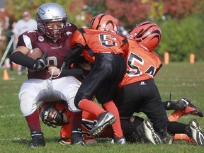 South Ottawa Mustangs FB Ahmed Merajah bowls over four Orléans Bengals on defenders for a score. (Submitted photo)