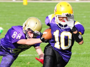 Tim Nanephosy (10), of the East Elgin Eagles, pulls away from Central Golden Ghosts defender John Ackerviller in their TVRA junior football clash Thursday in Aylmer. Nanephosy made two clutch receptions on the Eagles' final scoring drive as the teams played to a 21-21 tie.  (R. MARK BUTTERWICK, St. Thomas Times-Journal)