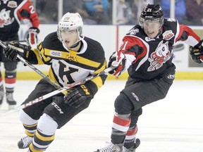 Kingston Frontenacs defenceman Roland McKeown tries to get past the Niagara IceDogs’ Carter Verhaeghe to get to the puck during an Ontario Hockey League game at the Rogers K-Rock Centre on Sept. 27. (Michael Lea/The Whig-Standard)