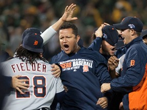 Detroit Tigers third baseman Miguel Cabrera (middle) celebrates with teammates, including Prince Fielder (left) after Game 5 of the American League Divisional Series against the Oakland Athletics at O.co Coliseum in Oakland October 10, 2013. (Ed Szczepanski/USA TODAY Sports)