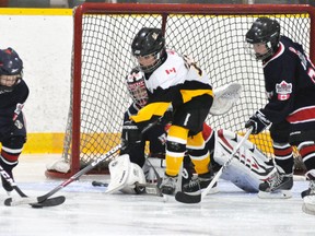 Darren Feltz of the Mitchell Atom AE’s gives chase to this St. Marys defender during exhibition hockey action last Monday, Oct. 7. The Meteors came out on the short end of a 3-2 result. ANDY BADER/MITCHELL ADVOCATE