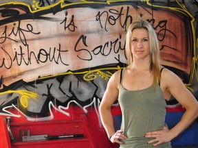 Shannon Ludlow stands in front of graffiti at Adrenaline Training Centre in London Ont. Oct. 10, 2013. CHRIS MONTANINI\LONDONER\QMI AGENCY