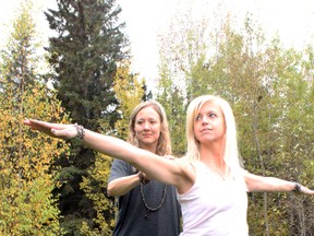 Retreat organizer Jennifer Parks offers corrections to St. Albert resident Marni Perry as she performs a yoga pose outside The River Lodge in Parkland County. Parks hosted her fifth annual fall yoga retreat at the lodge from Oct. 4 to 6. - Karen Haynes, Reporter/Examiner