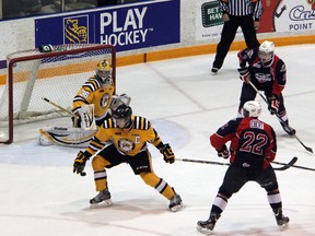 The Sarnia Sting beat the Windsor Spitfires 3-2 thanks to a late Anthony DeAngelo goal on Friday, Oct. 11, 2013. Pictured here is Sting captain Craig Duininck picking up one of his four blocked shots on the night. (The Observer file photo)