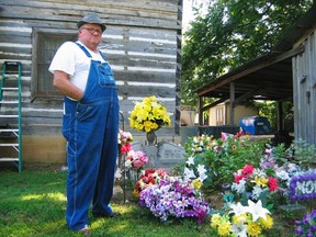 Jim Davis stands by the grave of his wife in the yard of their house in Stevenson, Alabama, July 16, 2012. Before she died, Patsy Davis let it be known that she wished to be buried in the yard of the house in which they raised their five children. (REUTERS/Tom Bassing)
