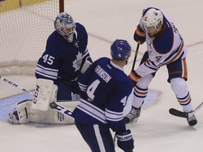 Leafs' Jonathan Bernier makes a save on Oilers forward Taylor Hall during Saturday night's game at the ACC. (JACK BOLAND/Toronto Sun)