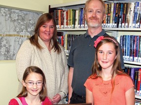 Lloyd Crosby and his sister Ann-Michele Timmerman, the children of late librarian Pat Crosby, were at the Vulcan Municipal Library Oct. 5 for the first-time presentation of the Pat Crosby Award for Eager Young Readers, which was given to Tracie Steiner, 10, and Raelene Bennik, 12.