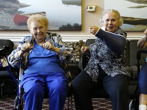 (From left) Martina McGoey, Bernice Walter  and Peggy McCruer take part in an exercise class at Riverwood Senior Living centre  last week. (CRAIG ROBERTSON, Toronto Sun)