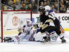 A stretched-Out Jason LaBarbera fails to stop a Chris Kunitz goal during second-period action Tuesday in Pittsburgh. (Charles LeClair, USA Today)