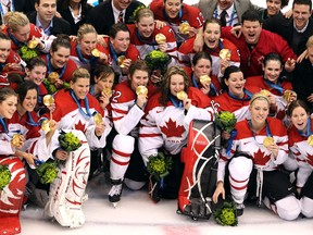 Canada's women's hockey team celebrates with gold medals after beating the U.S. at the 2010 Winter Olympics in Vancouver. (Andre Forget, QMI Agency)
