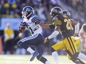 Argonauts wideout Dontrelle Inman sprints with the ball as Tiger-Cat Emanuel Davis chases him down during first-half action on Monday. (Ernest Doroszuk/Toronto Sun)