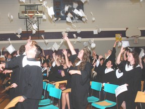 Graduating students at West Elgin Secondary School toss their caps into the air in celebration last week at a comencement ceremony.