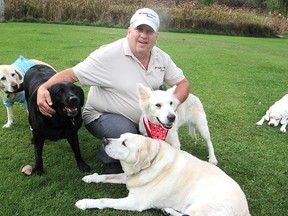 Bill McCormick, of Sheba's Haven Rescue, a shelter for terminally or seriously ill dogs on Sunbury Road, lets Clover (in red bandana), their newest arrival, meet some of their other dogs.
Michael Lea The Whig-Standard