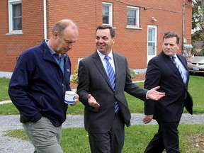 Ontario Progressive Conservative leader Tim Hudak, centre, speaks with Gary Oosterhof, left, owner of Oosterhof Electrical Services, as Kingston and the Islands candidate Mark Bain looks on. Hudak was visiting Kingston on Wednesday.
Ian MacAlpine The Whig-Standard