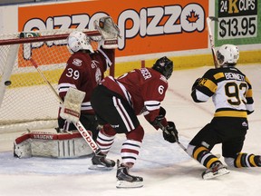 Forward Sam Bennett scores Kingston’s opening goal on Guelph Storm goaltender Justin Nichols as defenceman Phil Baltisberger looks on early in the second period of Sunday’s Ontario Hockey League game at the Rogers K-Rock Centre. Kingston, which lost the game 9-3, will play its next six games on the road. (Elliot Ferguson/The Whig-Standard)