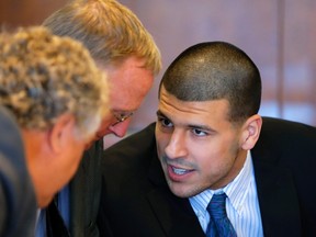Aaron Hernandez (right), formerly of the NFL's New England Patriots, talks to defence attorneys Michael Fee (left) and Charles Rankin during a court appearance at the Bristol County Superior Court in Fall River, Massachusetts October 9, 2013. (REUTERS/Brian Snyder)