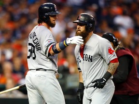 Jarrod Saltalamacchia congratulates Mike Napoli for his seventh-inning home run during Game 3 on Tuesday. (Getty Images)