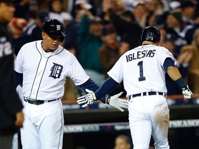 Detroit Tigers shortstop Jose Iglesias (1) is congratulated by third baseman Miguel Cabrera after scoring against the Boston Red Sox during Game 4 of the American League Championship Series at Comerica Park October 16, 2013. (Rick Osentoski/USA TODAY Sports)